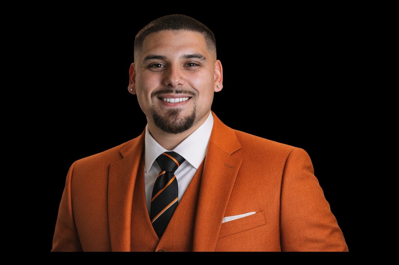 Junior, founder of Stay The Course Society, in an orange suit